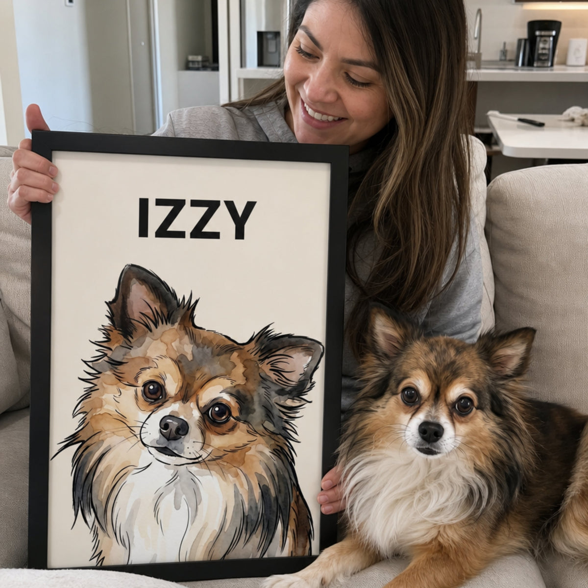 Smiling woman holding a framed custom watercolor Chihuahua portrait personalized with the name Izzy beside her dog.