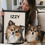 Smiling woman holding a framed custom watercolor Chihuahua portrait personalized with the name Izzy beside her dog.