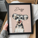 Framed custom watercolor dog portrait personalized with the name Daisy on a soft pink background.