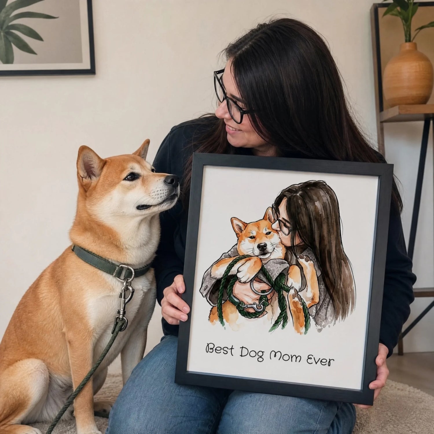 Customer holding a framed pet and owner portrait beside her dog